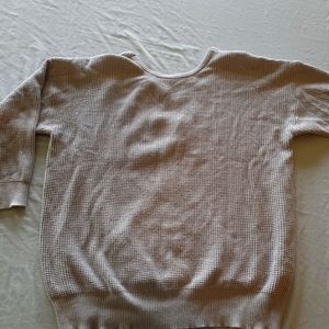 Light grey sweater with open back.